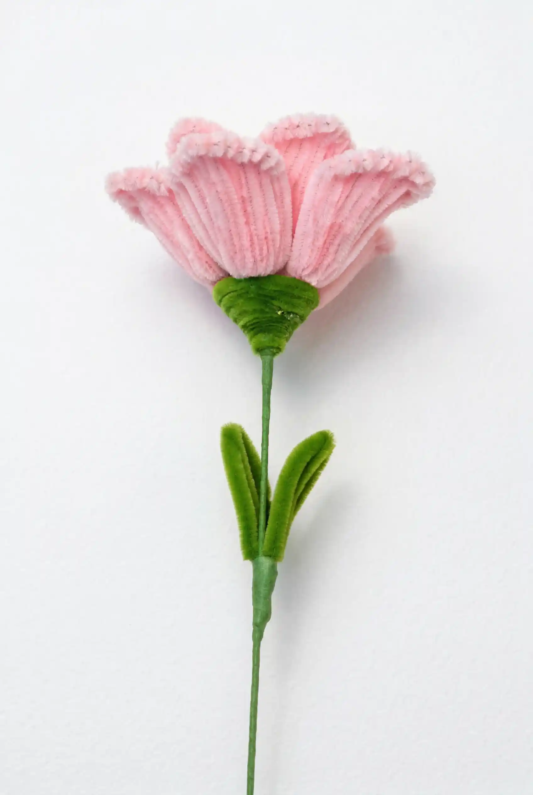 Full stem view of a finished artisan-made Glint Garden pink Lisianthus soft sculpture bloom