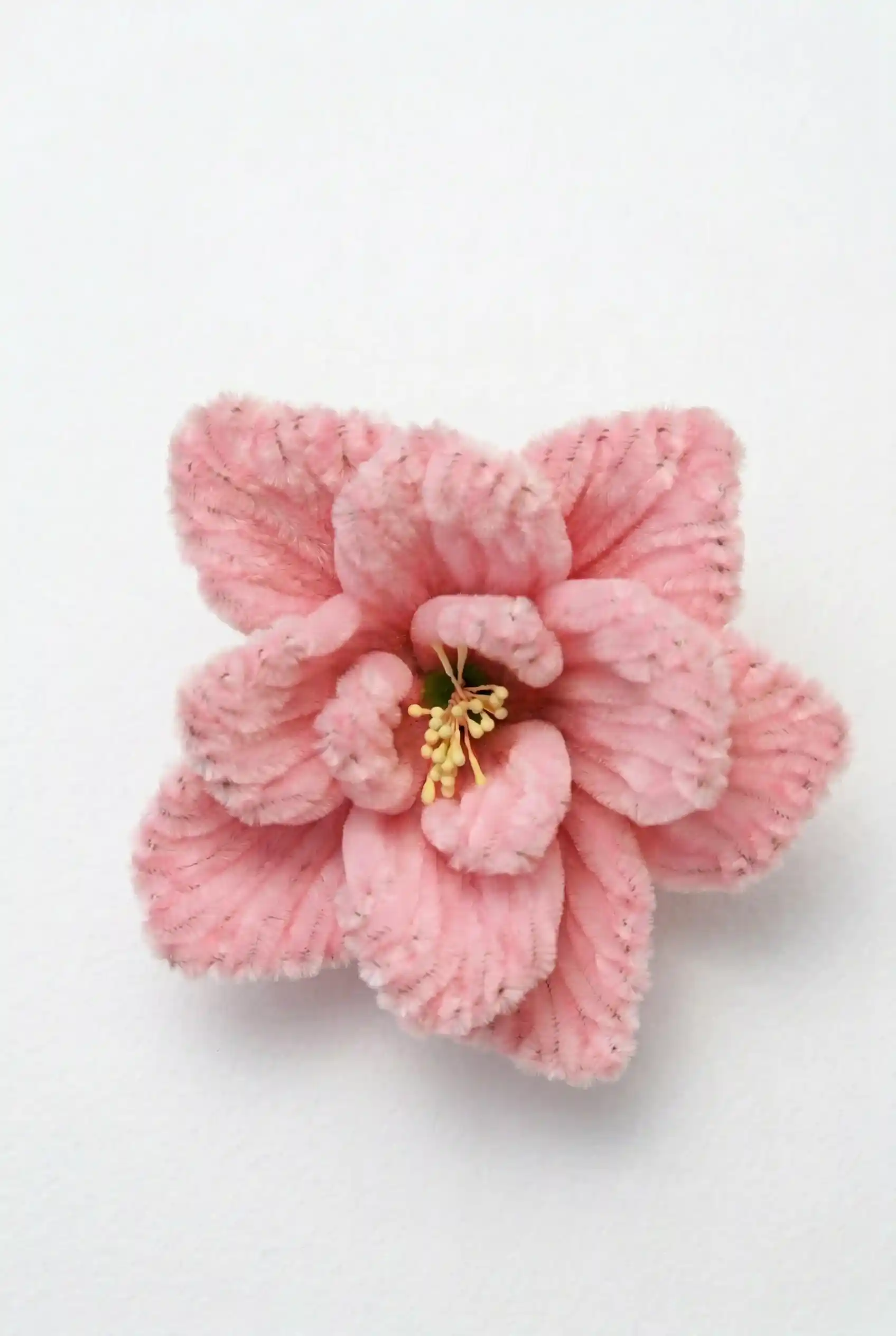 Close-up detail of a finished Glint Garden pink Lisianthus soft sculpture, showing the velvety chenille fibers.