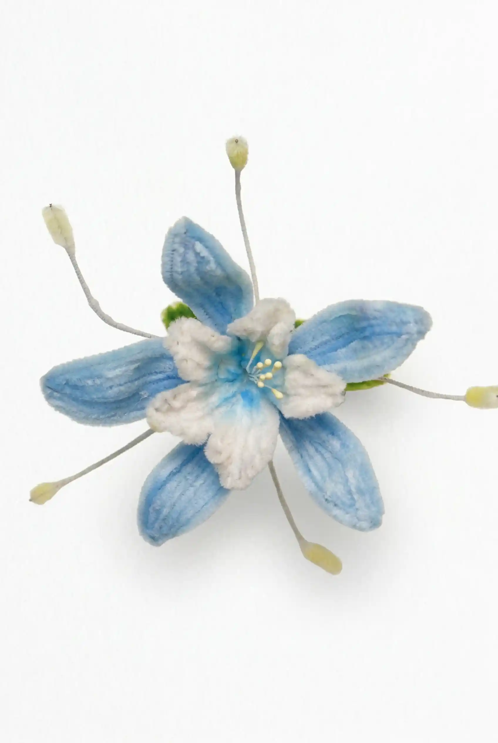 Top-down view of a finished handmade Blue Star flower (Tweedia) soft sculpture by Glint Garden, featuring azure petals and white center.