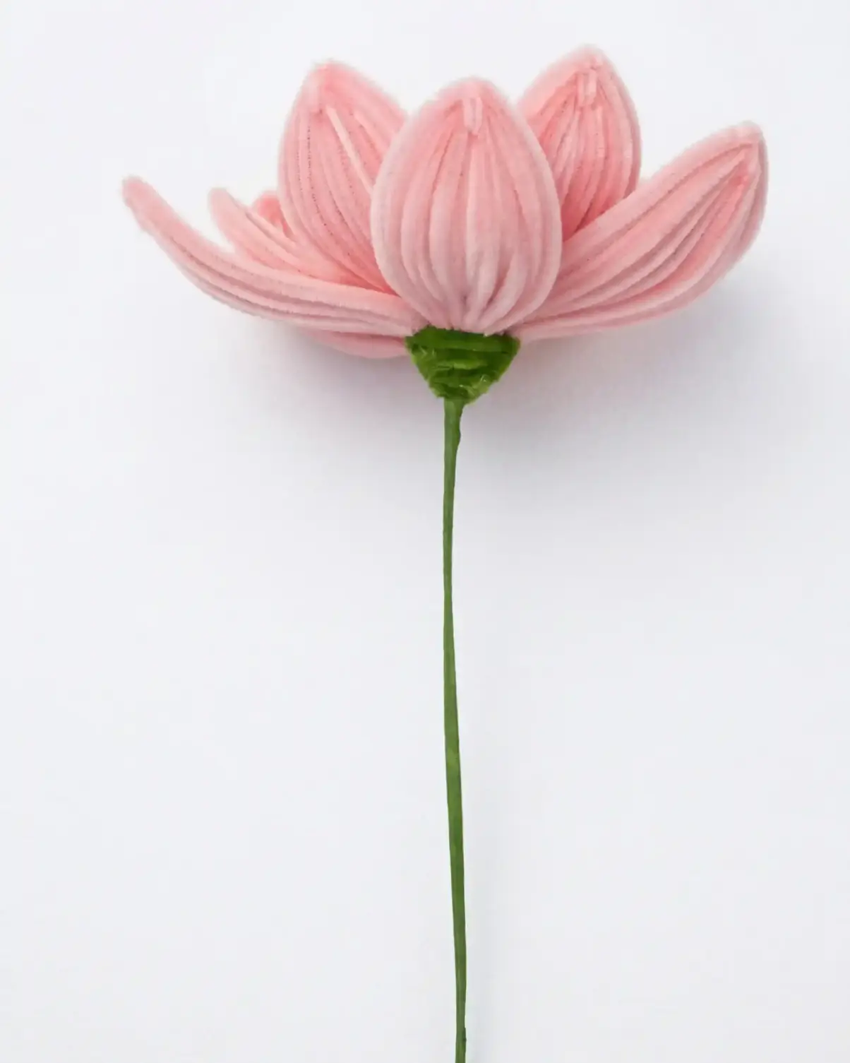 Side view of a finished handmade pink lotus soft sculpture by Glint Garden, showing layered chenille petals.