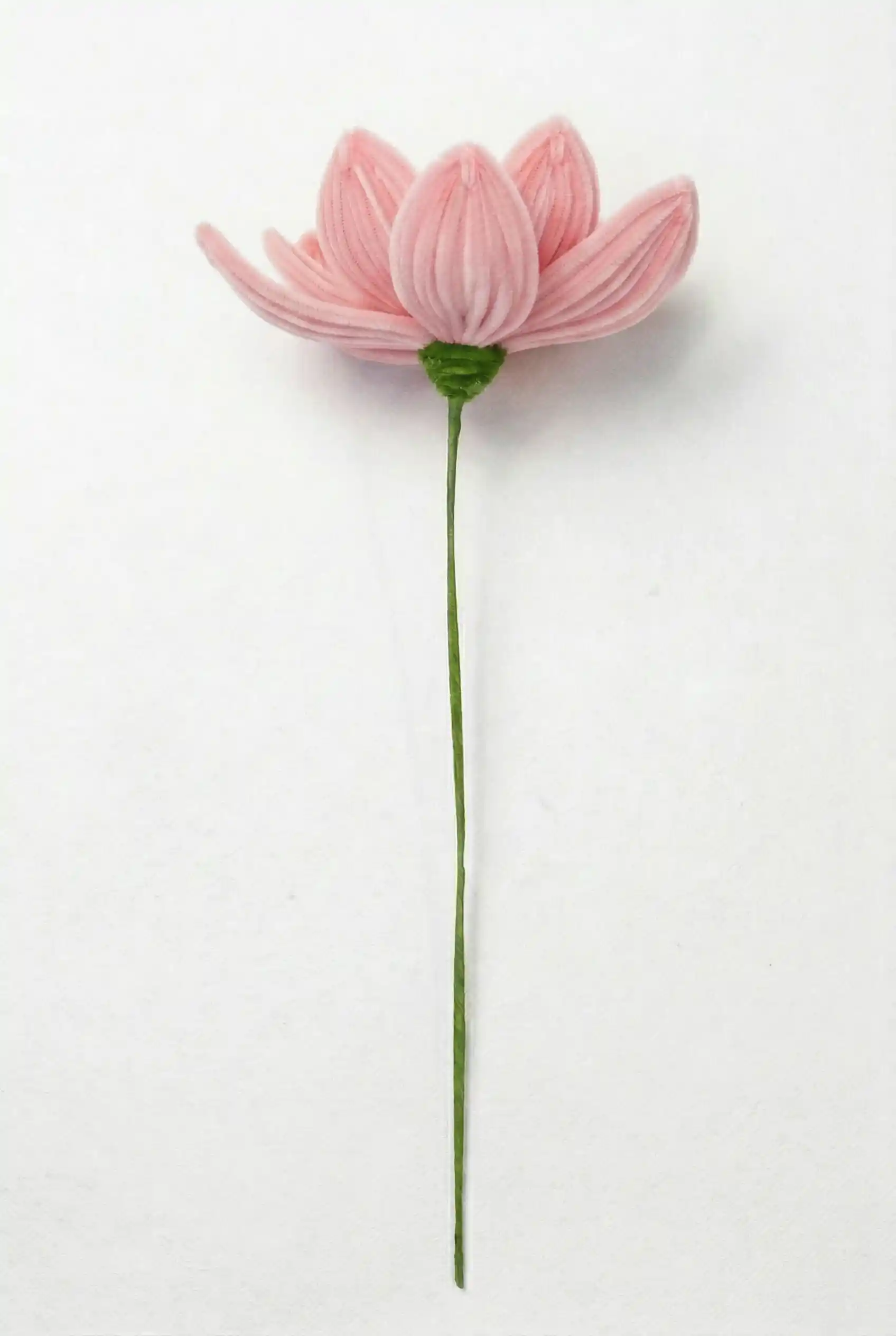Side view of a finished handmade pink lotus soft sculpture by Glint Garden, showing layered chenille petals.