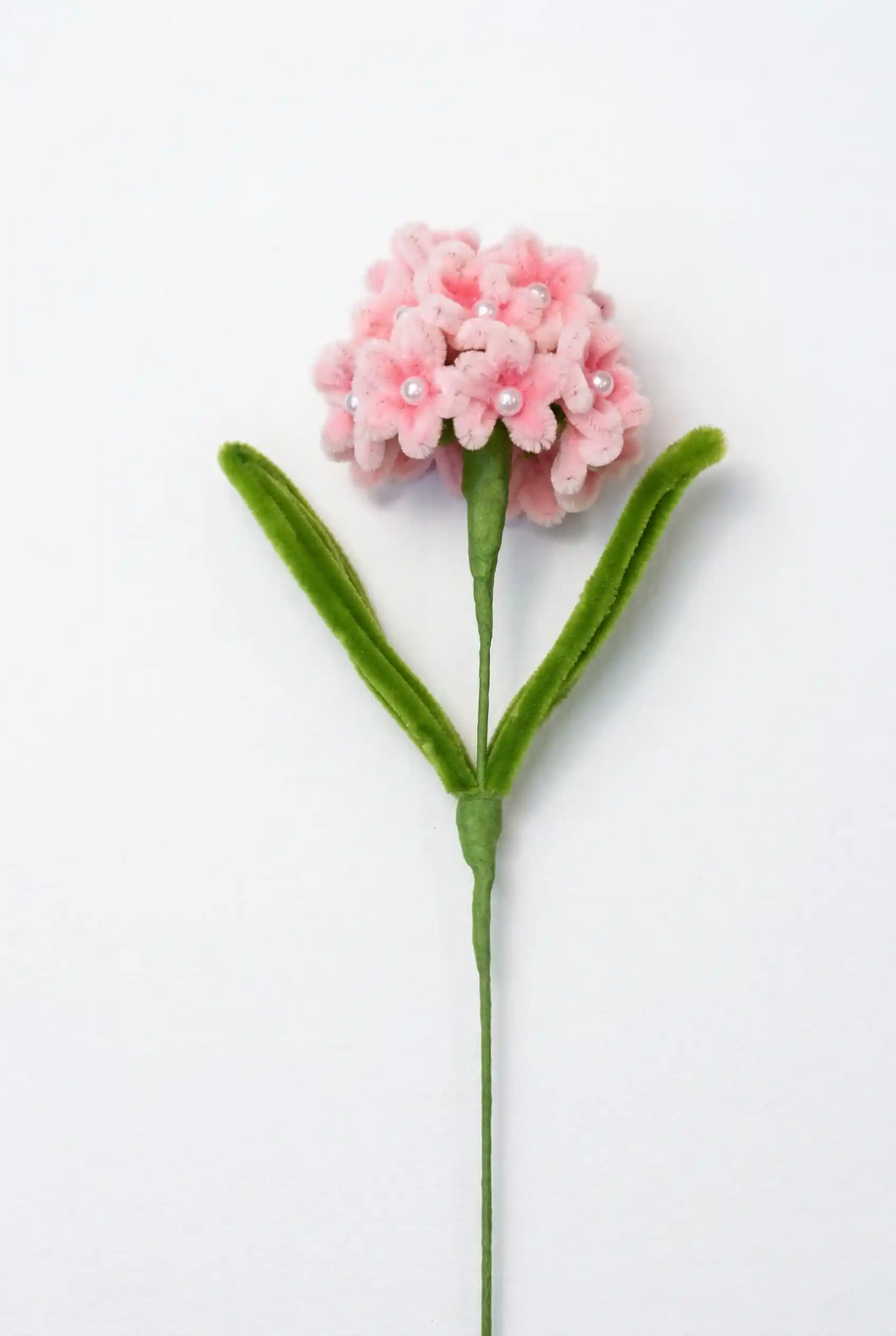 Full stem view of a finished artisan-made pink and purple gradient hydrangea soft sculpture by Glint Garden.
