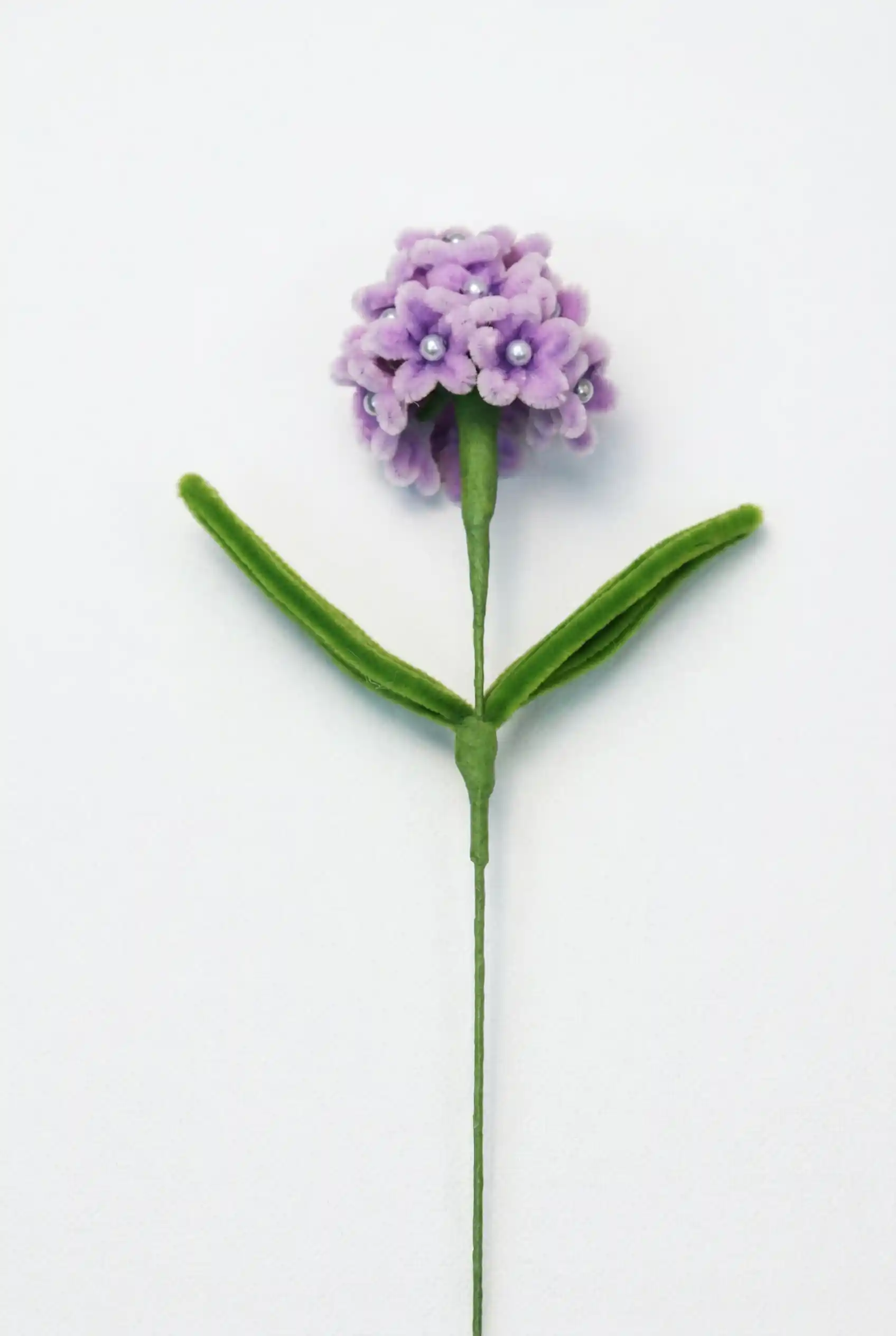 Full stem view of a finished artisan-made pink and purple gradient hydrangea soft sculpture by Glint Garden.