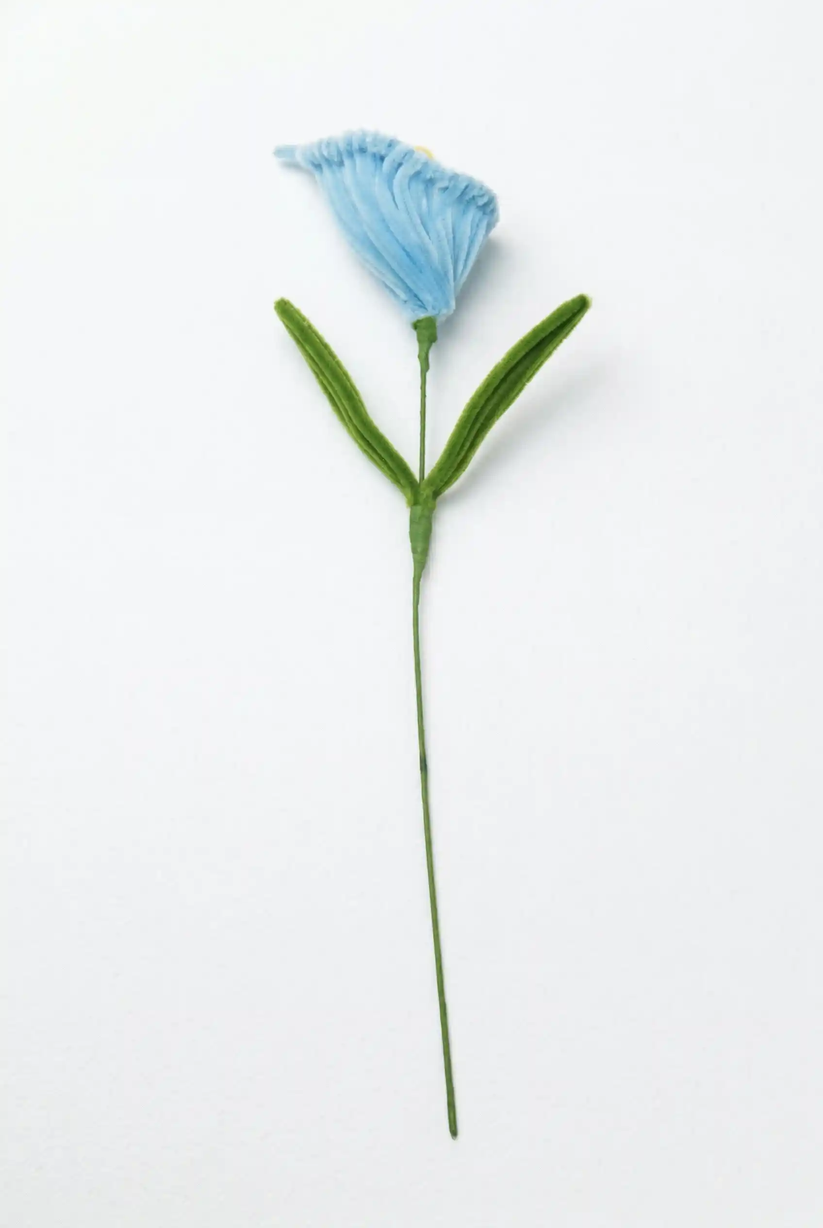 Full stem view of a finished artisan-made blue Calla Lily, an everlasting soft sculpture for minimalist home decor.