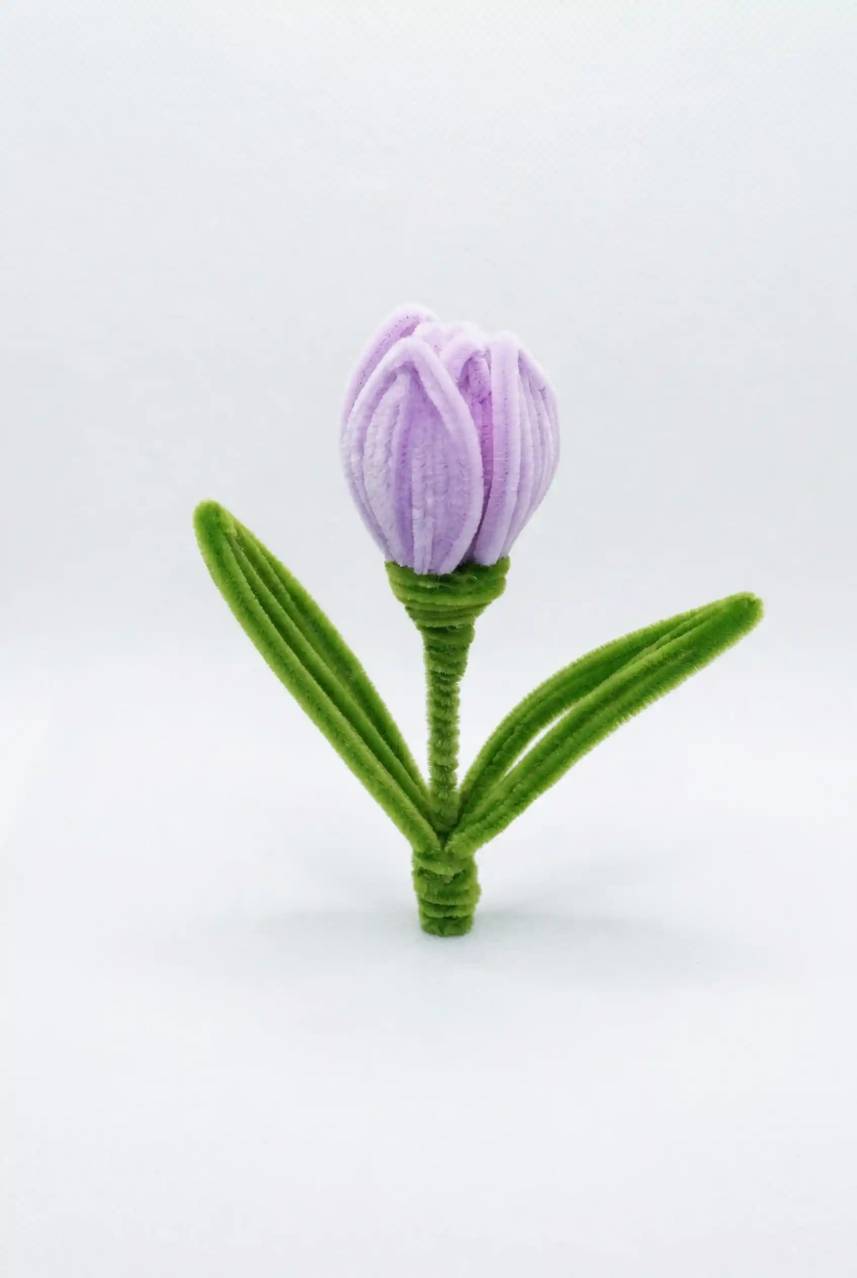 Close-up of a finished handmade lavender tulip soft sculpture by Glint Garden, featuring velvety purple petals.