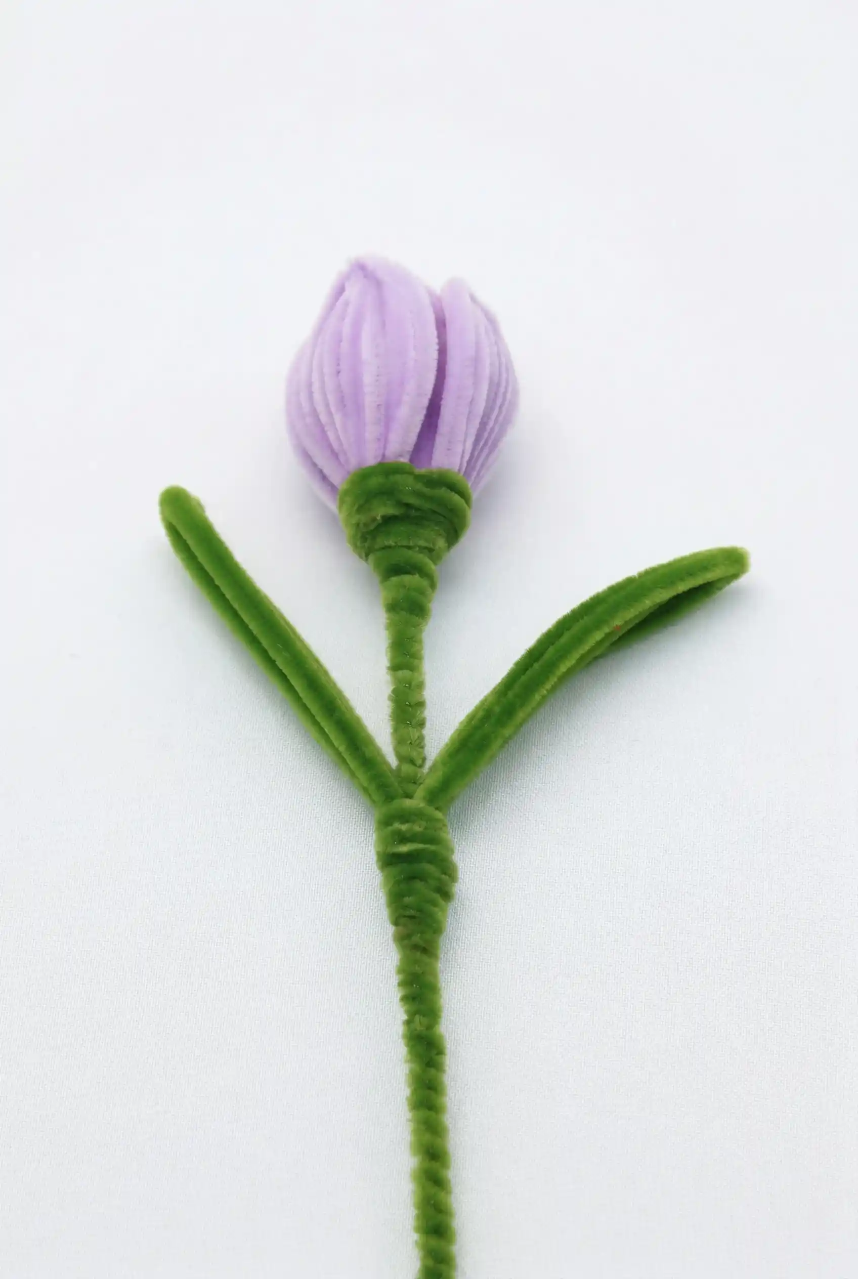 Close-up of a finished handmade lavender tulip soft sculpture by Glint Garden, featuring velvety purple petals.