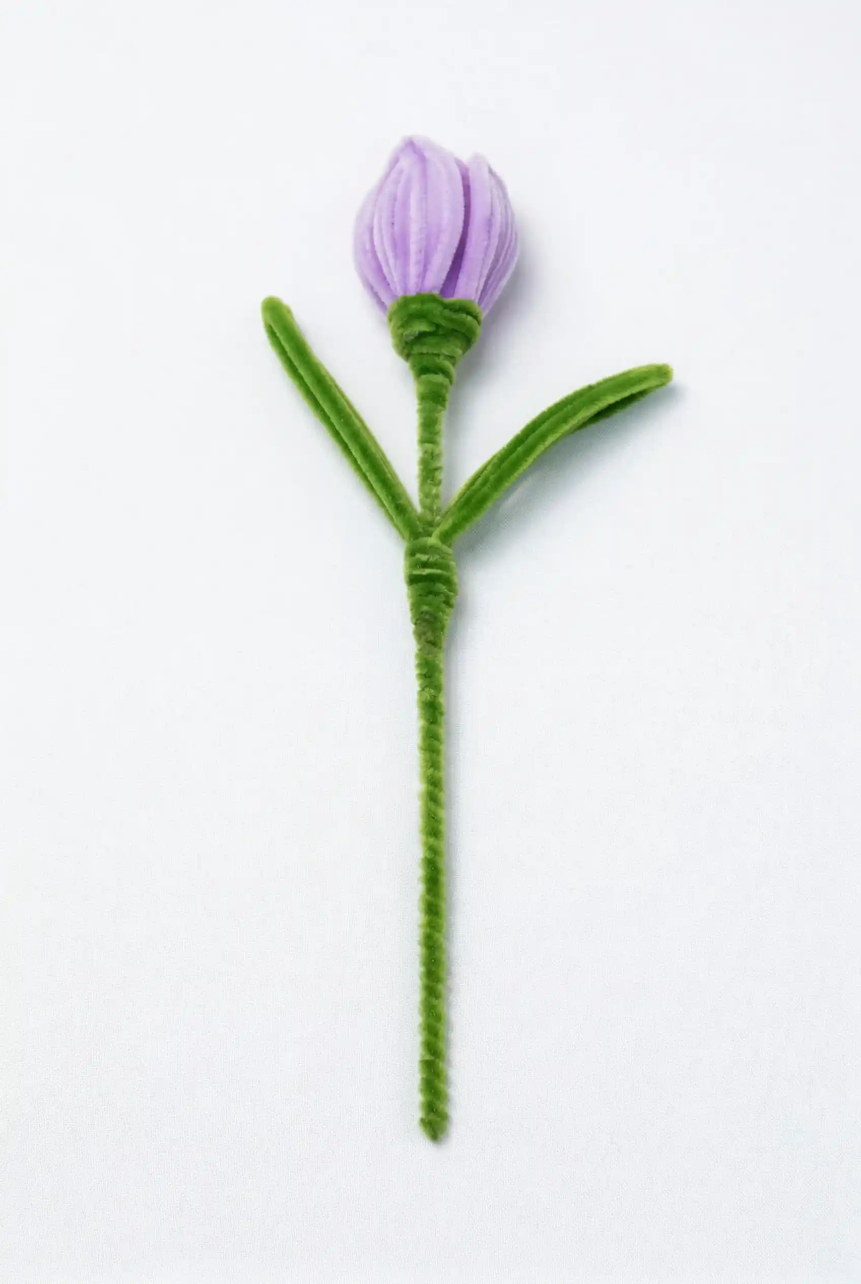 Full stem view of a finished artisan-made purple tulip, a perfect spring decor piece for minimalist homes.