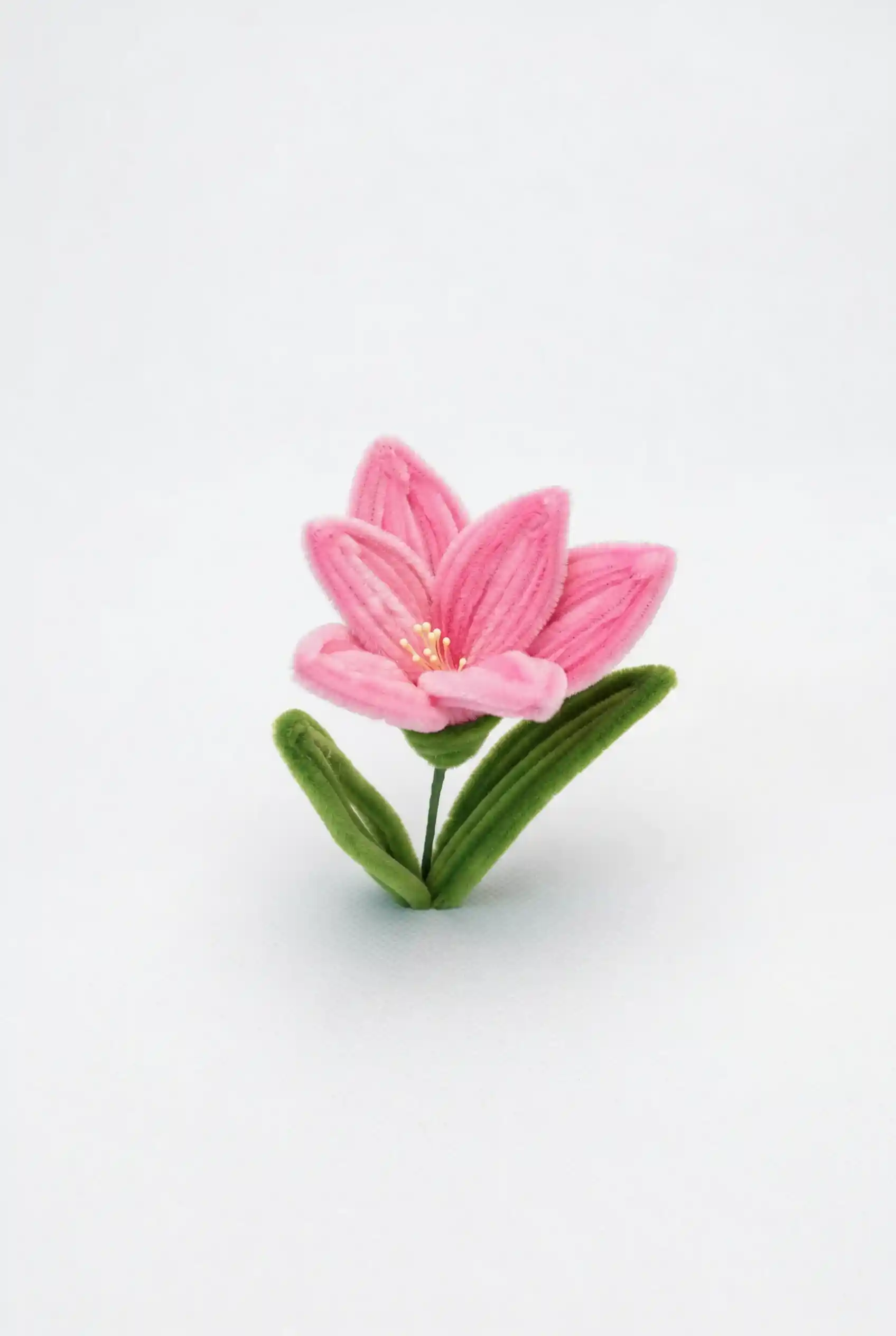 Close-up of a handcrafted pink Alstroemeria bloom showing velvet texture and petal gradients.