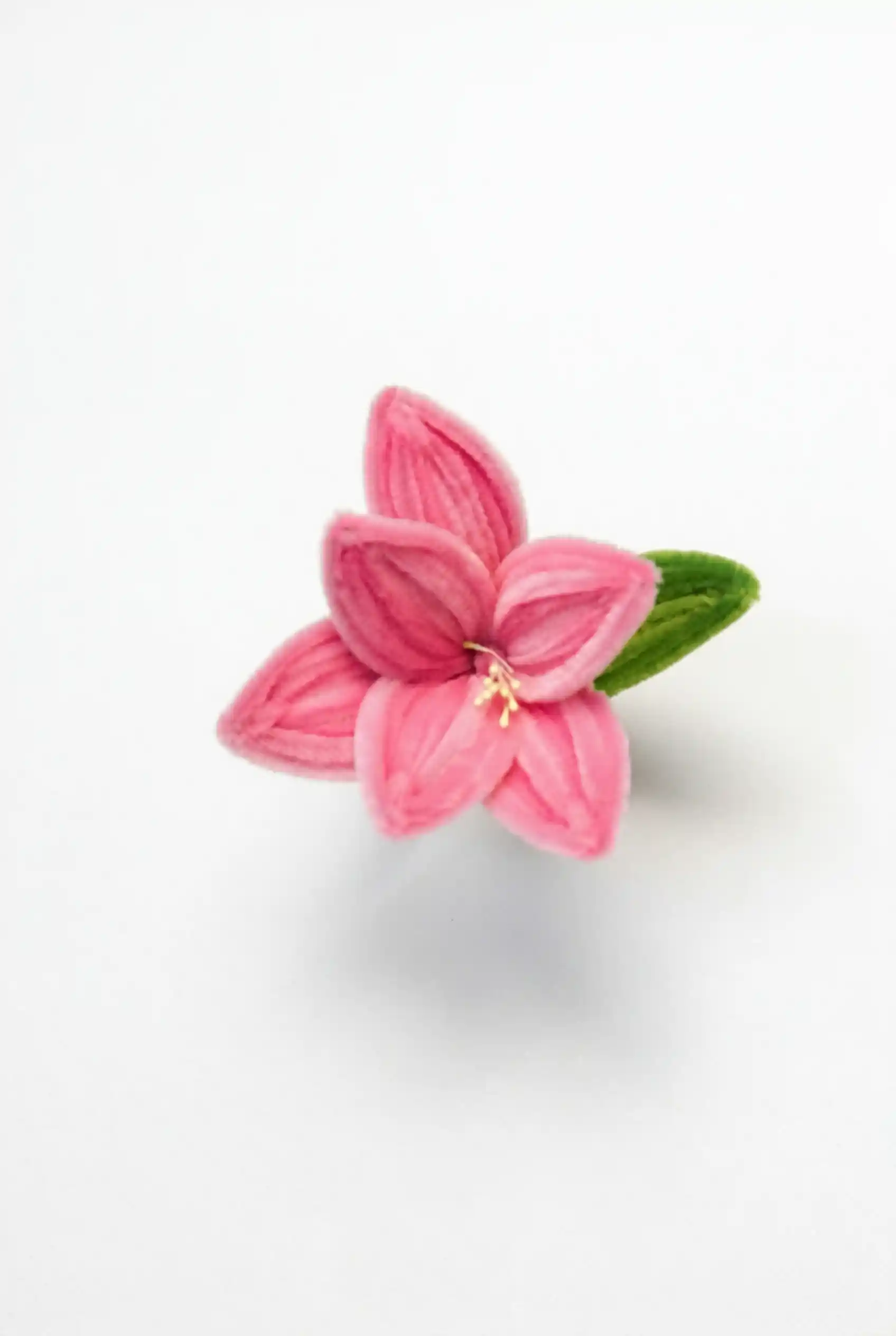 Close-up of a handcrafted pink Alstroemeria bloom showing velvet texture and petal gradients.