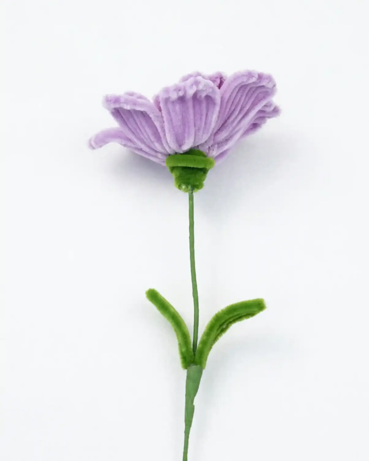 Close-up of a finished handmade lavender Ranunculus soft sculpture by Glint Garden, showing dense, layered velvet petals.