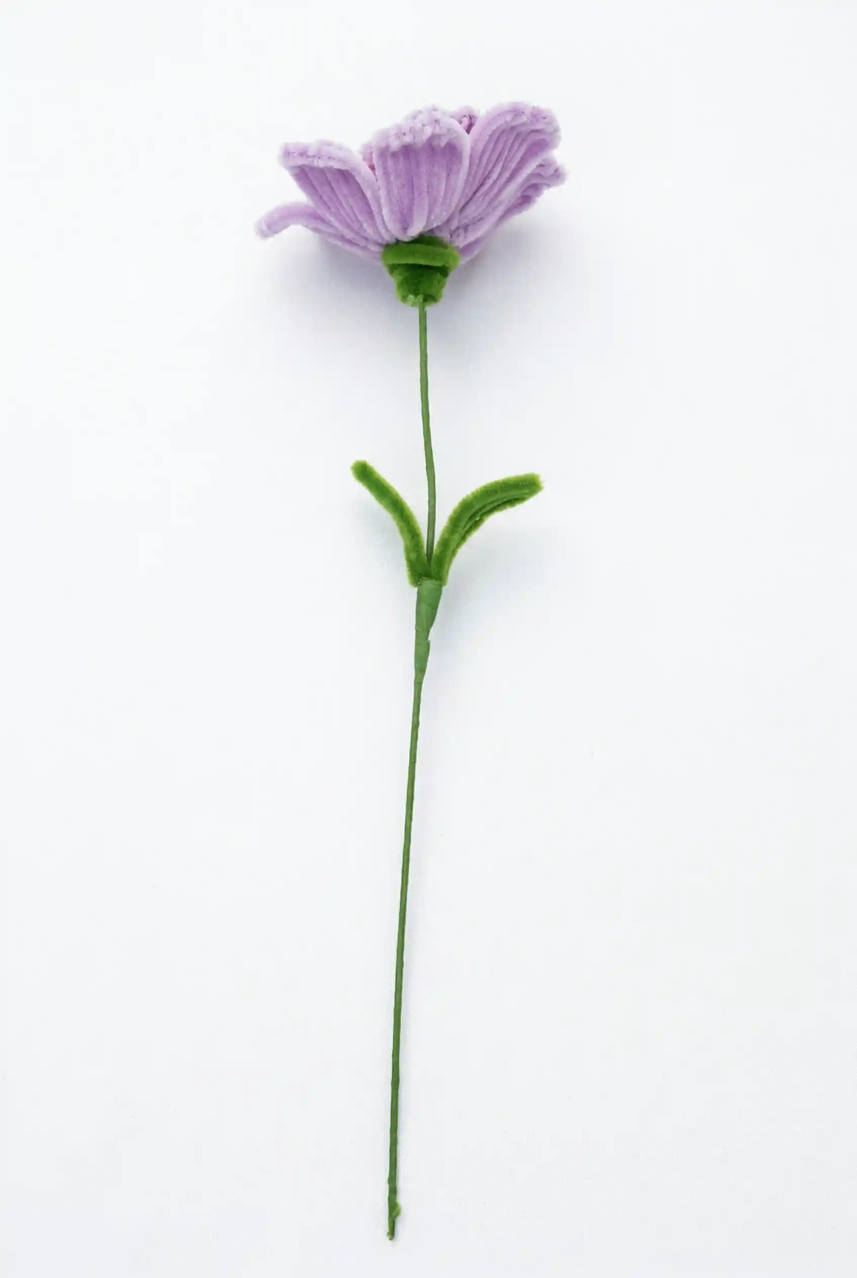 Full stem view of a finished artisan-made purple Ranunculus (Persian Buttercup) with green leaves, a luxury floral decor piece.
