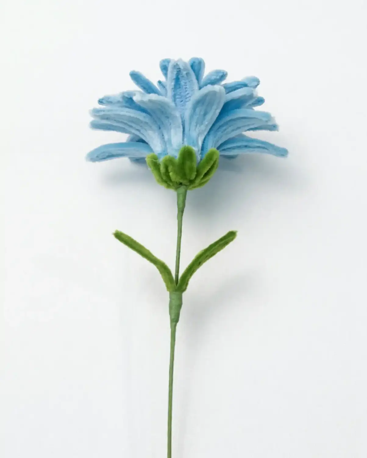 Side profile of a finished artisan-crafted Dahlia flower on a long stem, featuring a sculptural silhouette and vibrant colors.