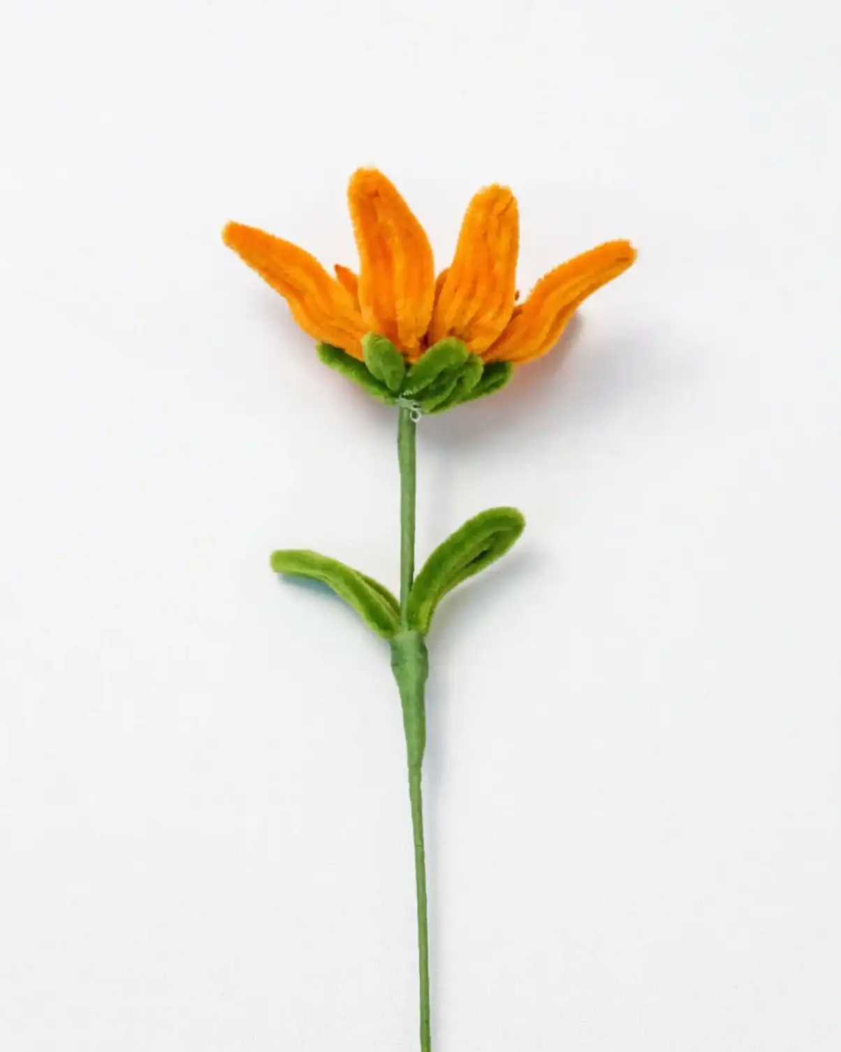 Close up view of a finished handmade Glint Garden oil painting style sunflower soft sculpture with dynamic leaf.