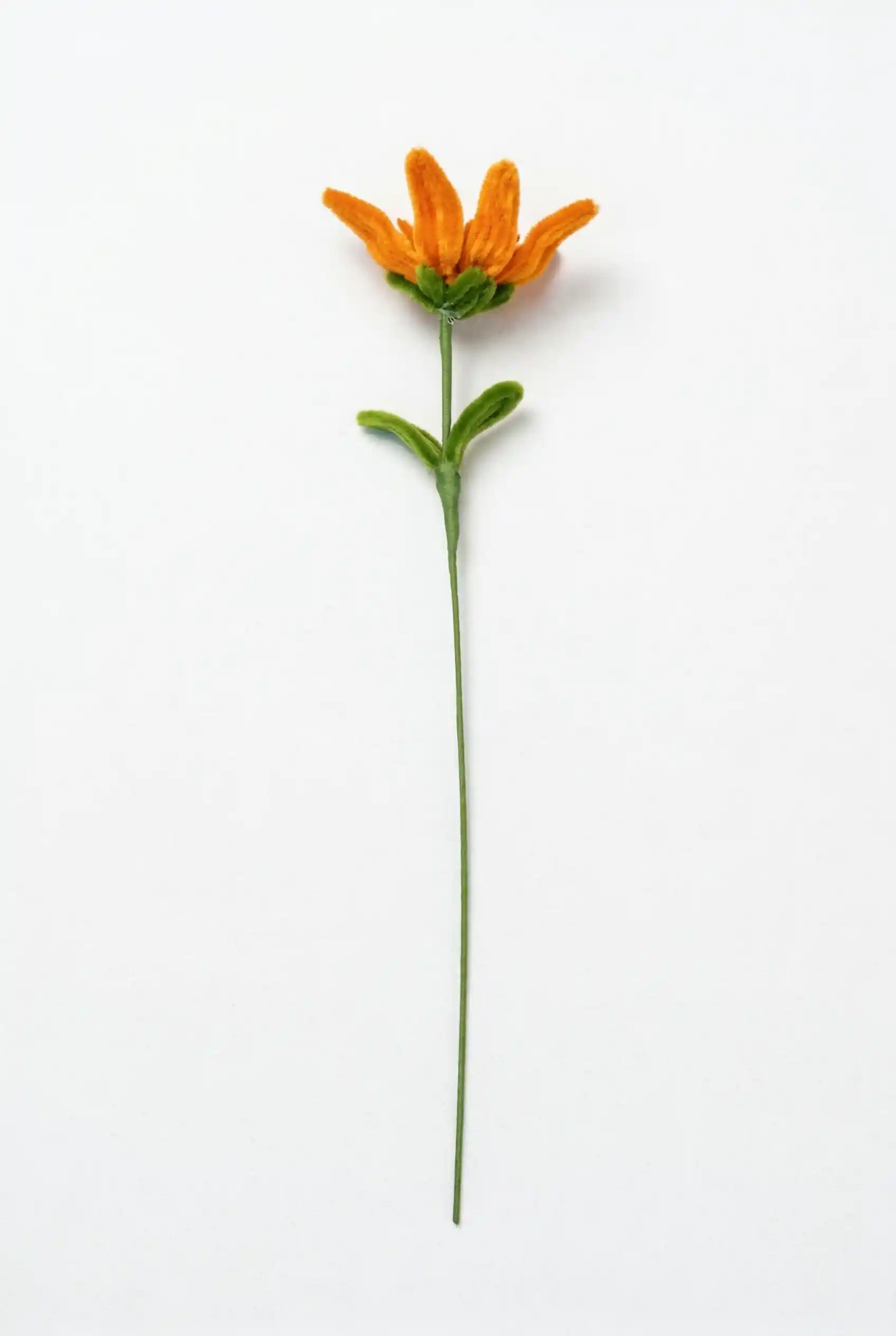 Full stem view of a finished handmade Glint Garden oil painting style sunflower soft sculpture with dynamic leaf.
