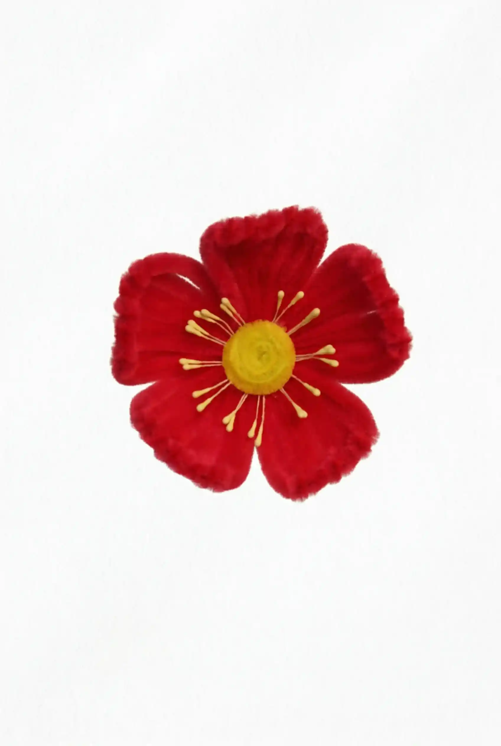 Top-down view of a finished handmade red Poppy soft sculpture by Glint Garden, featuring a sunny yellow center.