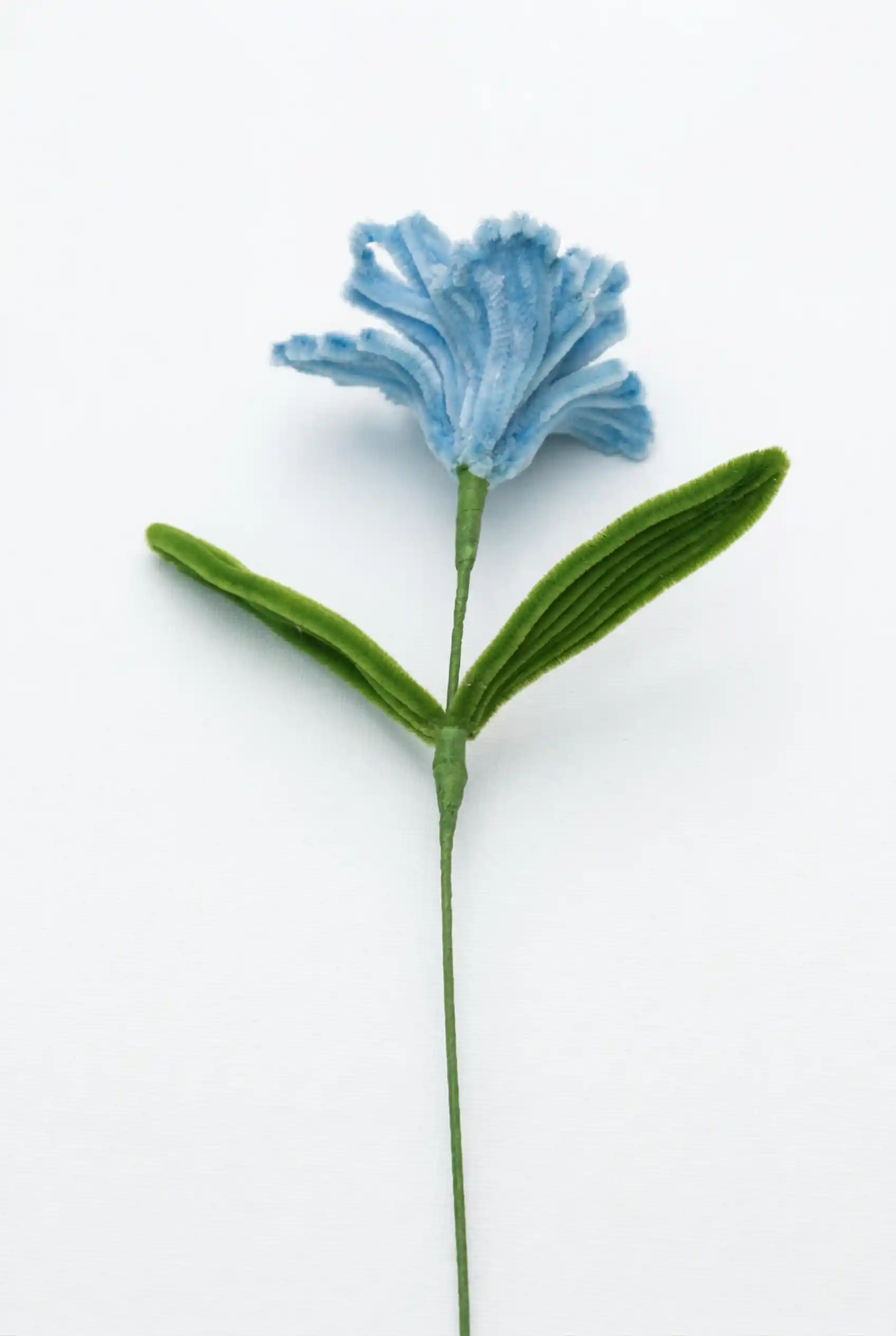 Full stem view of a finished artisan-made blue Iris, an architectural statement piece for minimalist home decor.