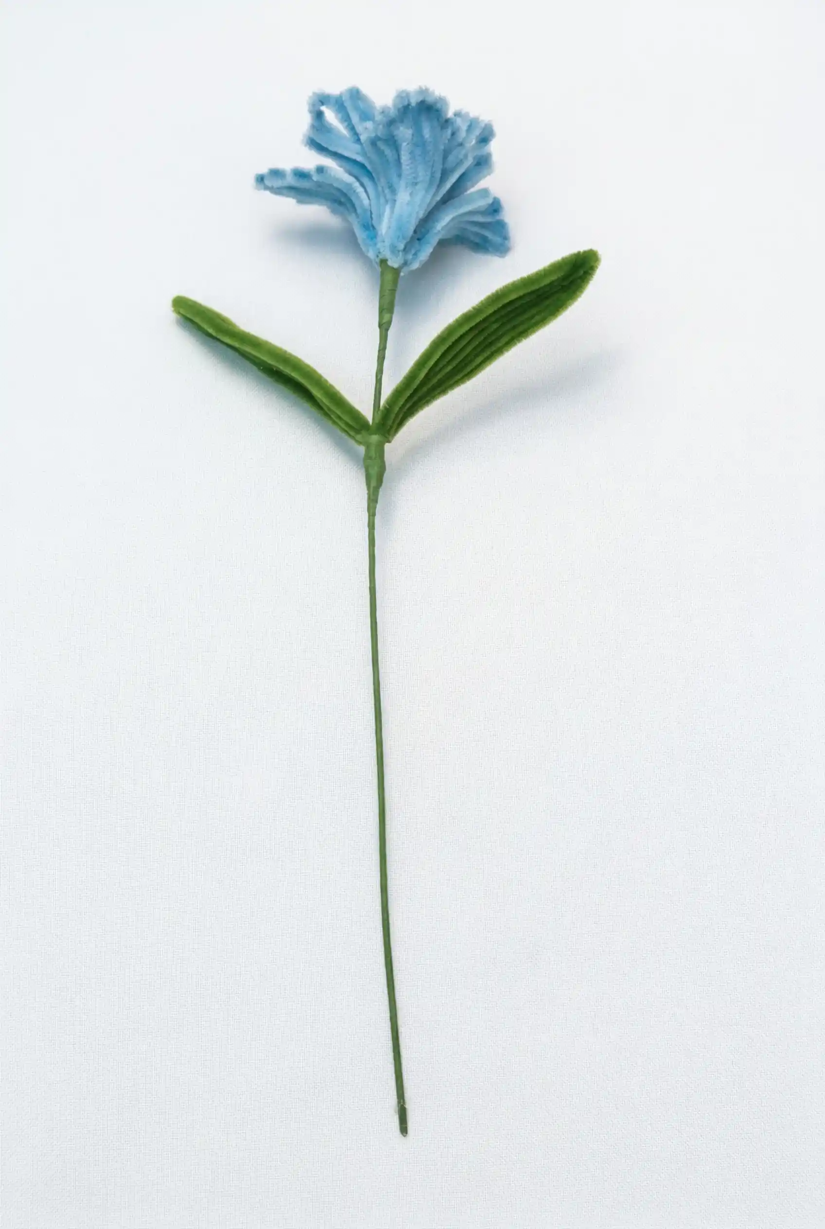 Full stem view of a finished artisan-made blue Iris, an architectural statement piece for minimalist home decor.