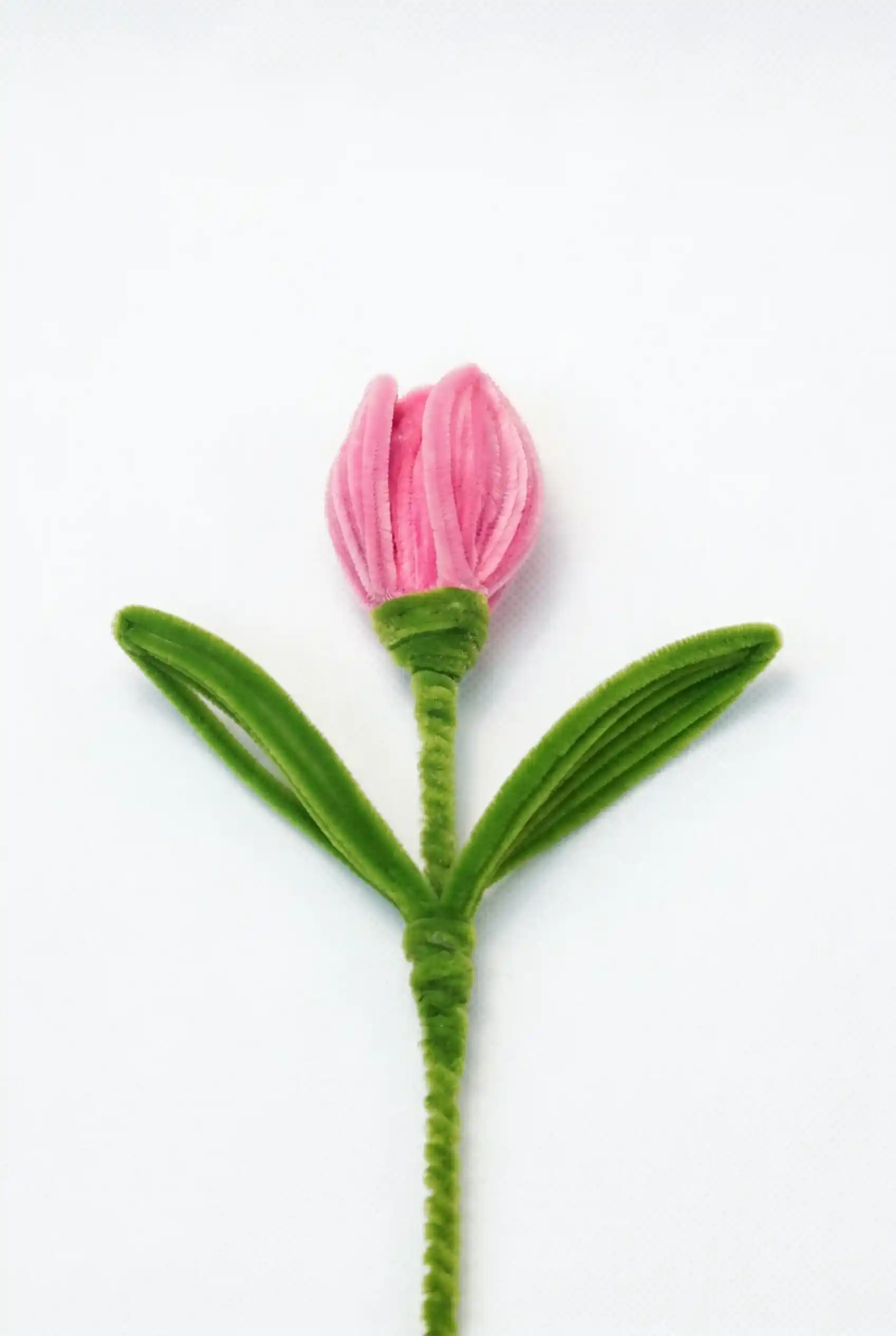 A finished artisan-made pink tulip on a long stem, a perfect everlasting floral piece for minimalist home decor.