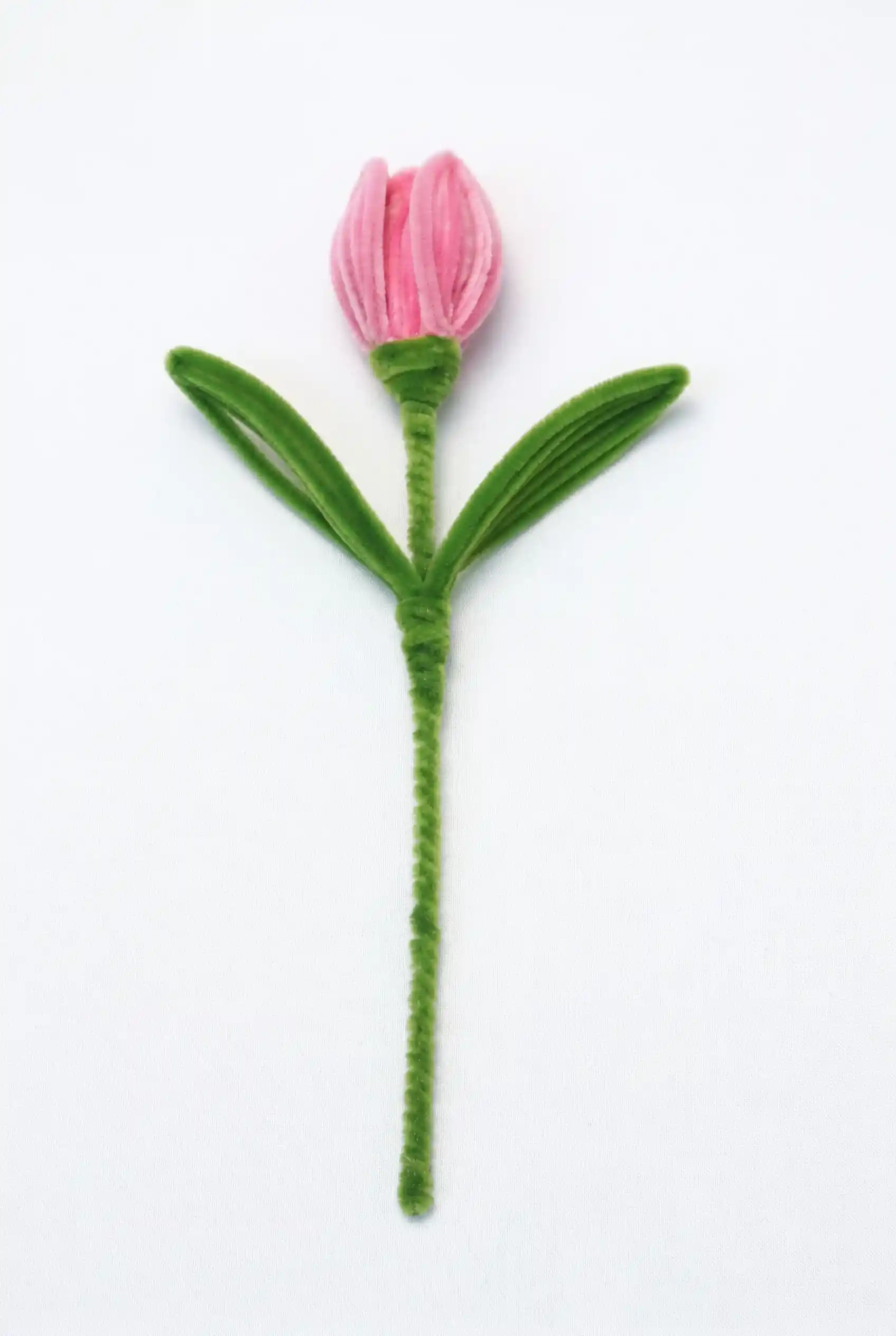 A finished artisan-made pink tulip on a long stem, a perfect everlasting floral piece for minimalist home decor.