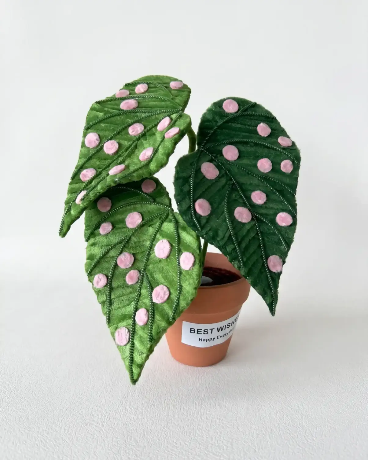 A handmade Begonia Maculata (Polka Dot Begonia) made from chenille stems in a small terracotta pot.