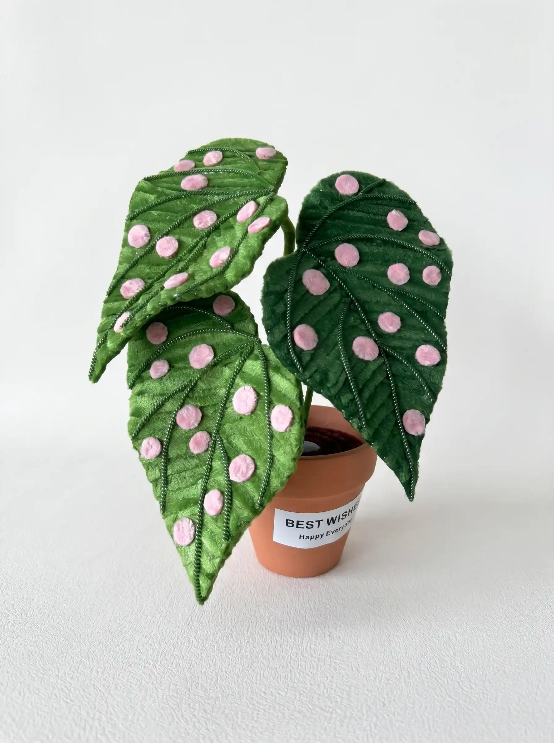 A handmade Begonia Maculata (Polka Dot Begonia) made from chenille stems in a small terracotta pot.