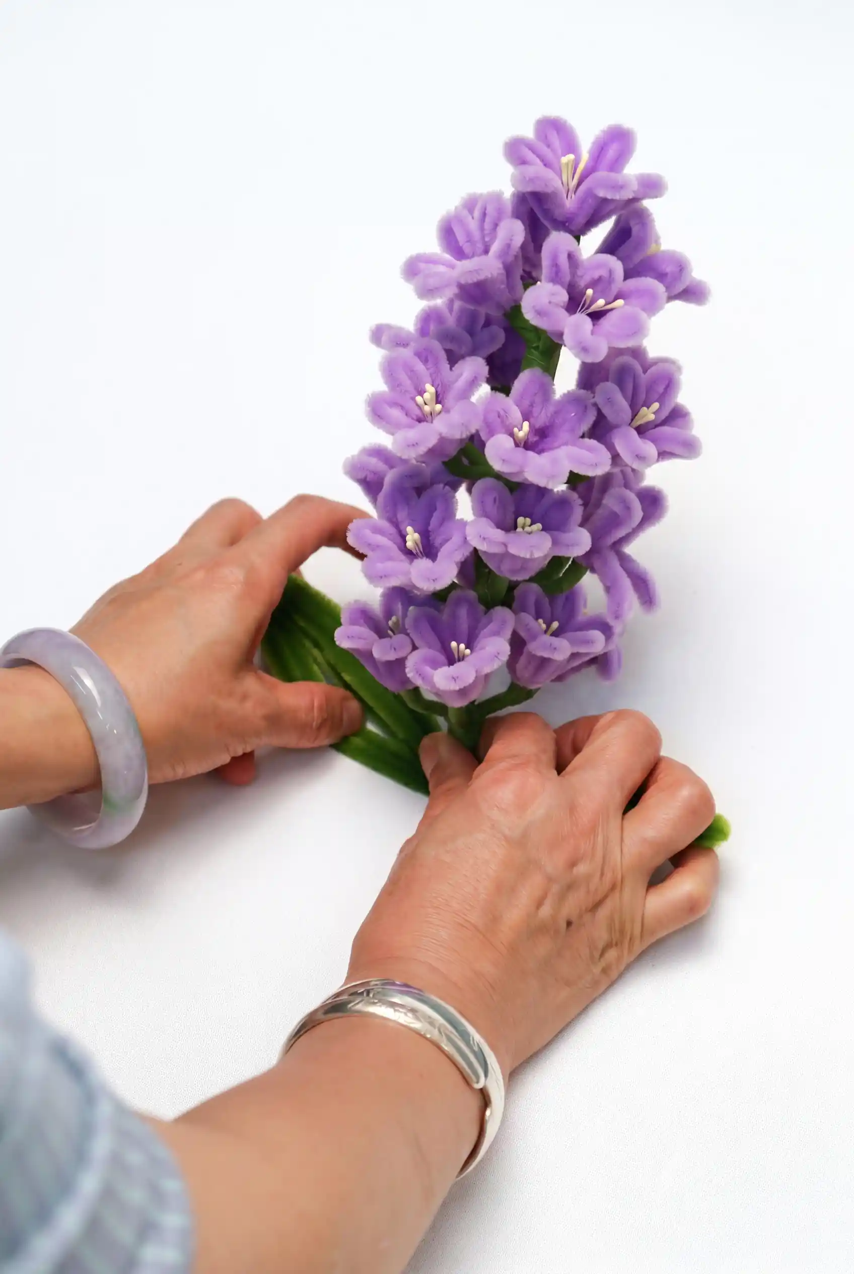 a handcrafted chenille hyacinth flower cluster showing the intricate multi-bloom structure.
