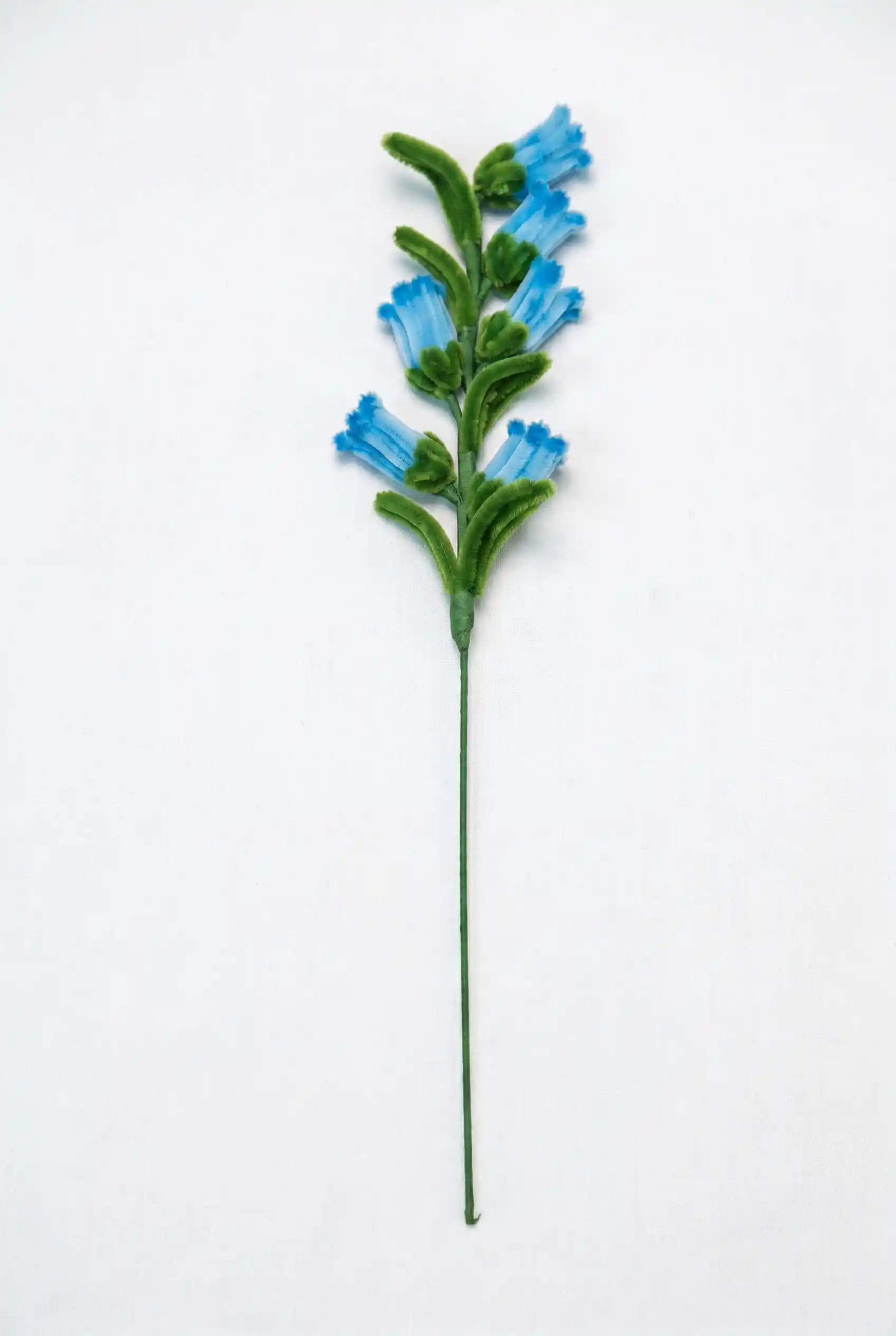Side view of a finished handmade bluebell soft sculpture with delicate azure florets by Glint Garden.