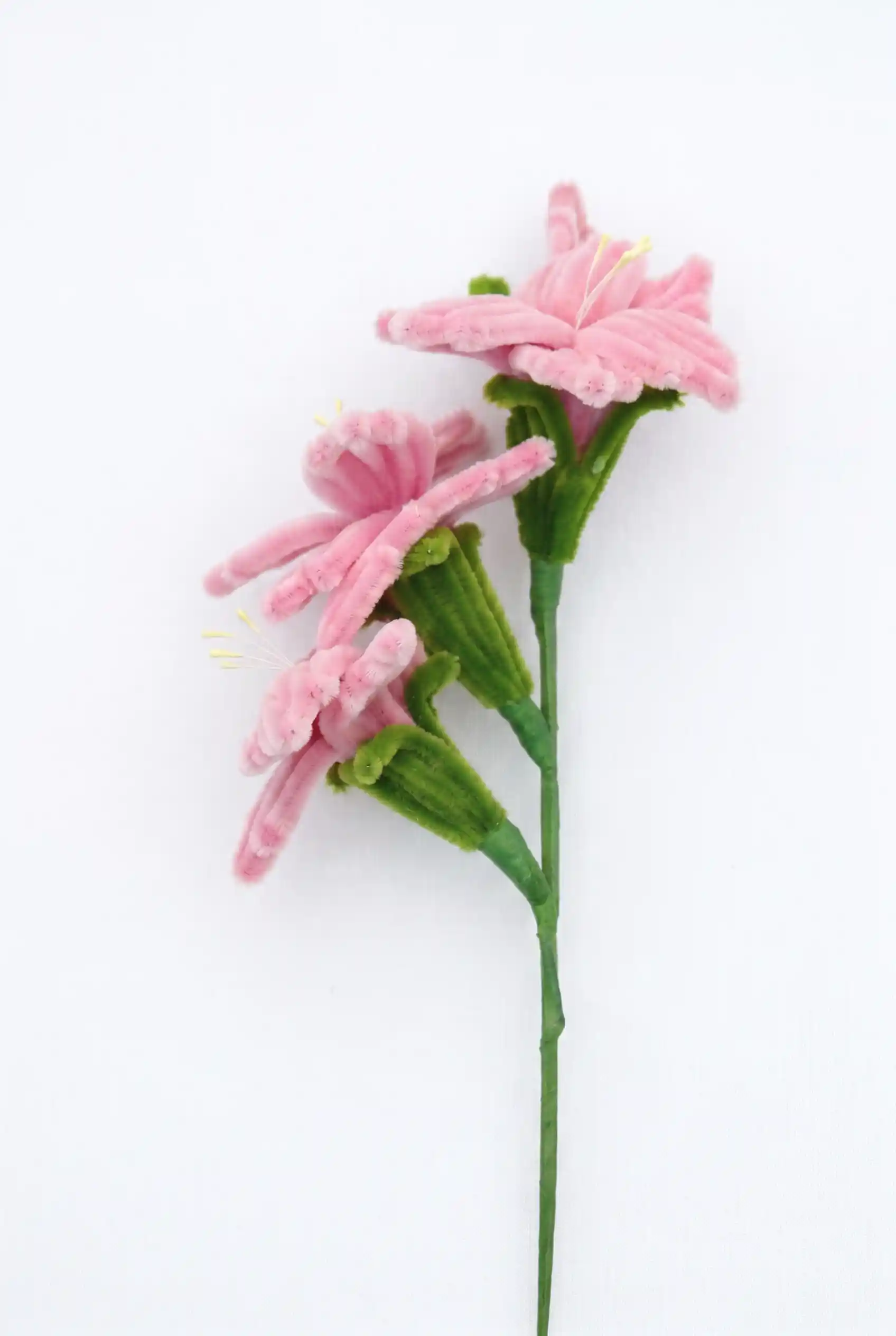 Side profile of a finished artisan-made pink Sword Lily stem, highlighting its elegant upward growth silhouette.