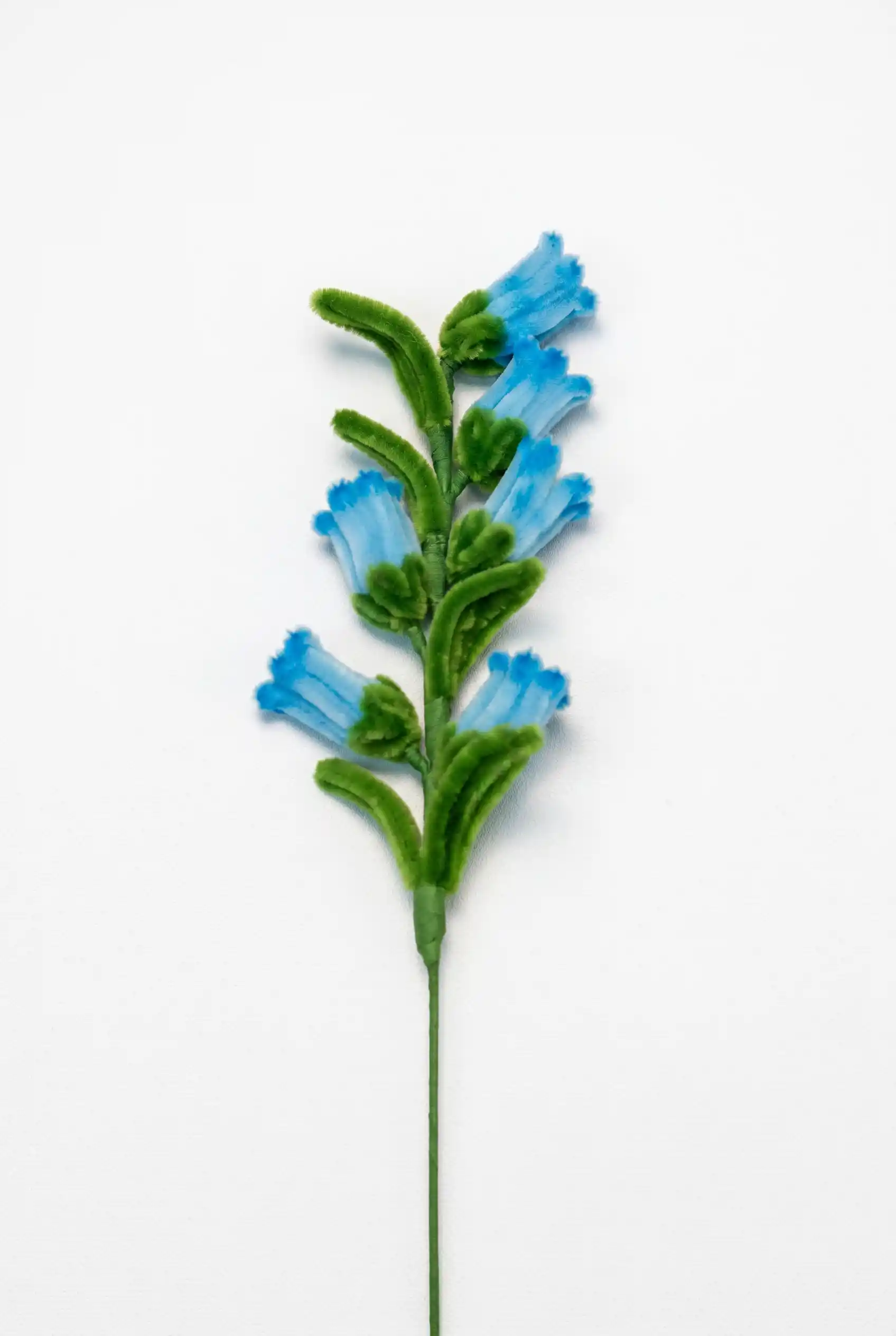 Close-up of a handcrafted chenille bluebell flower cluster showing the delicate bell-shaped structure.