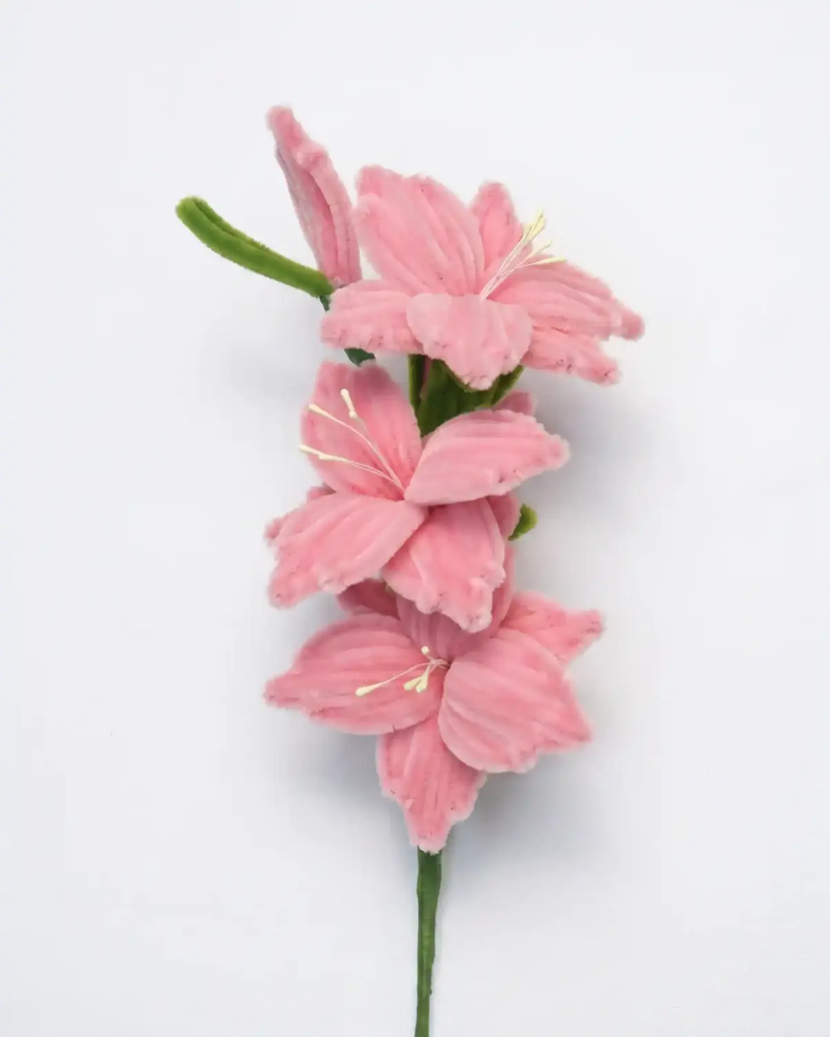 Close-up of a finished handmade pink Gladiolus soft sculpture showing three blooming florets on a stem.