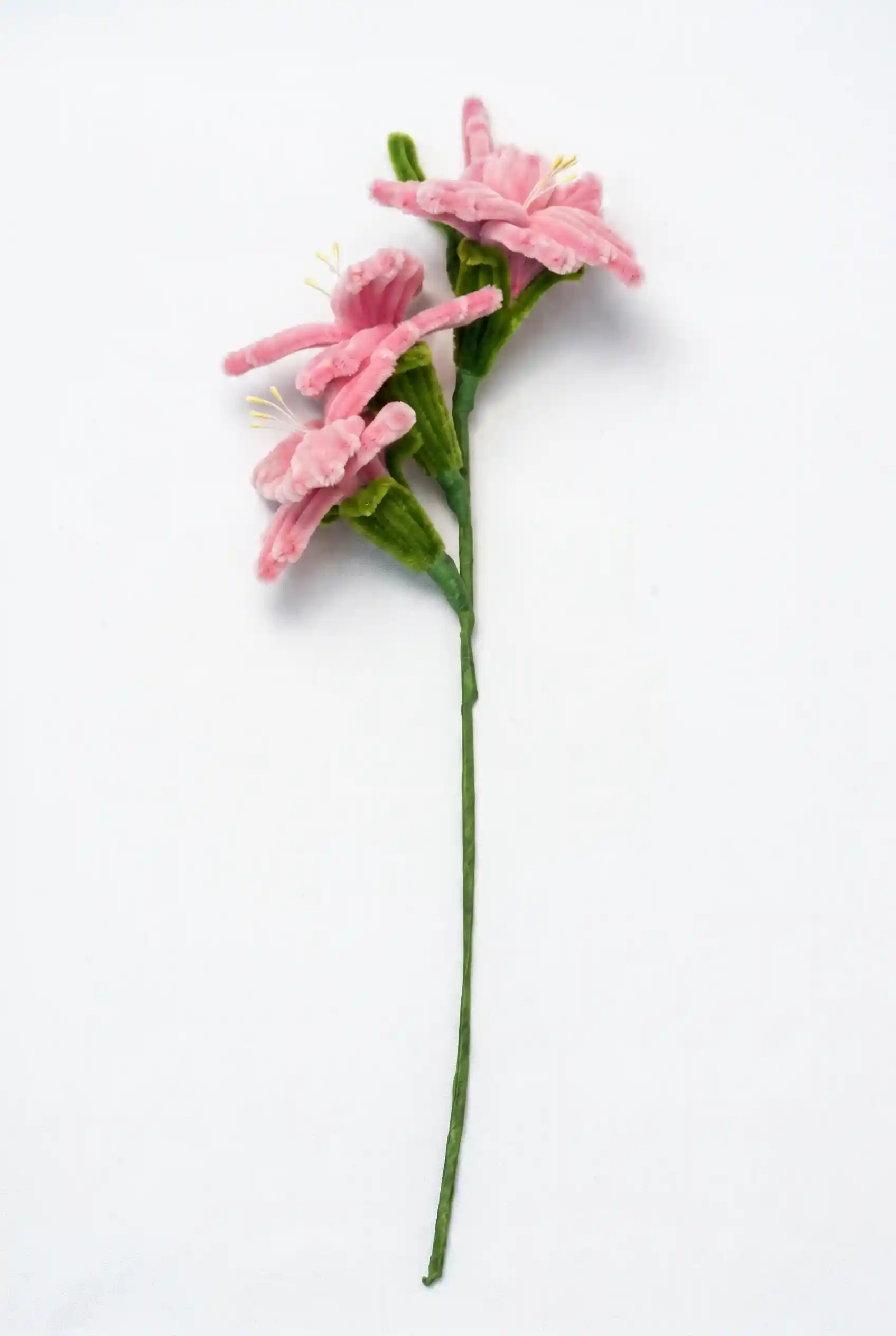 Side profile of a finished artisan-made pink Sword Lily stem, highlighting its elegant upward growth silhouette.