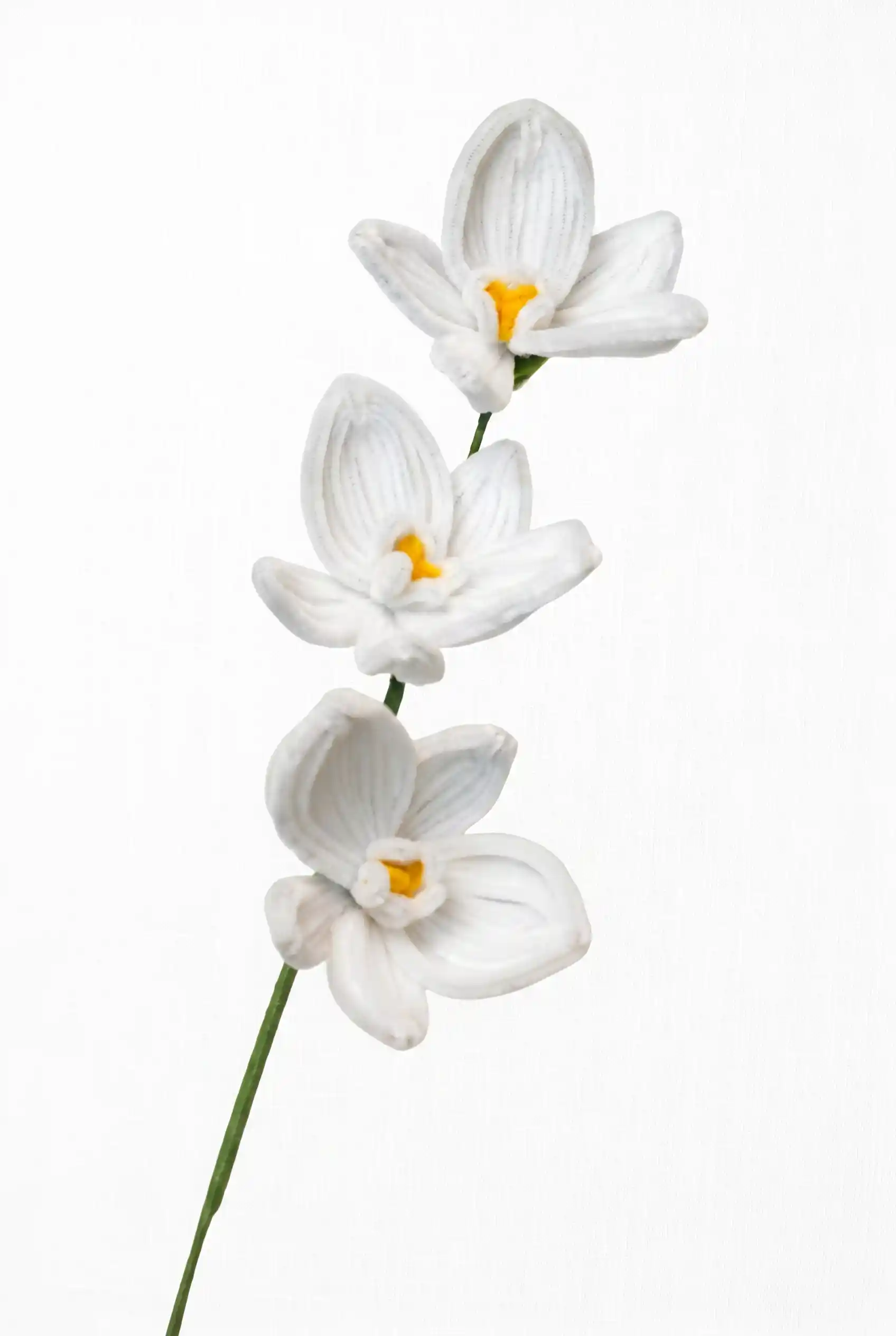 Front view of a finished handmade white Phalaenopsis orchid with three blooms and yellow centers by Glint Garden.
